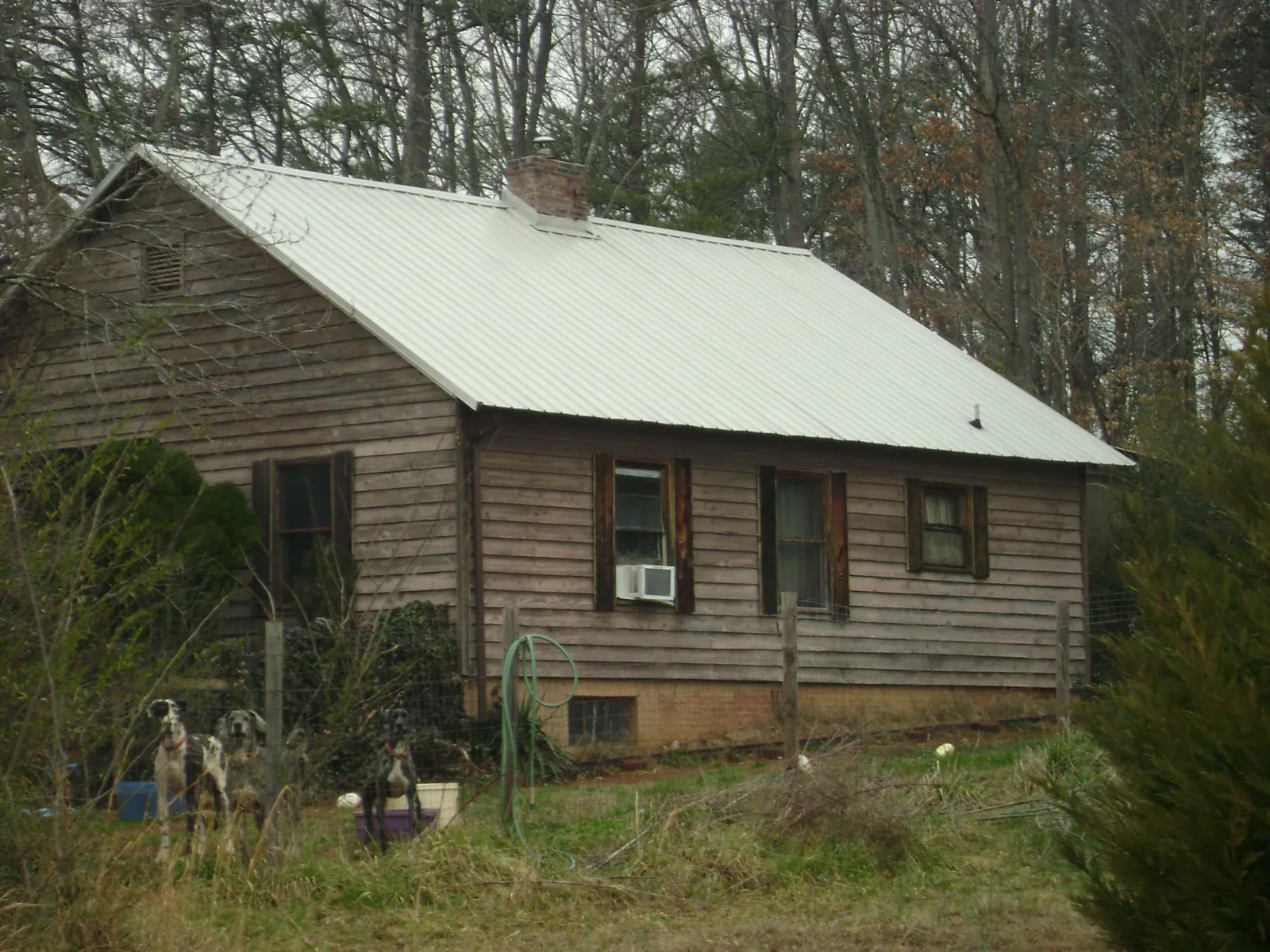 White metal roof on an old wood sided farmhouse, from a Metal Roof Installation job in Hicksville